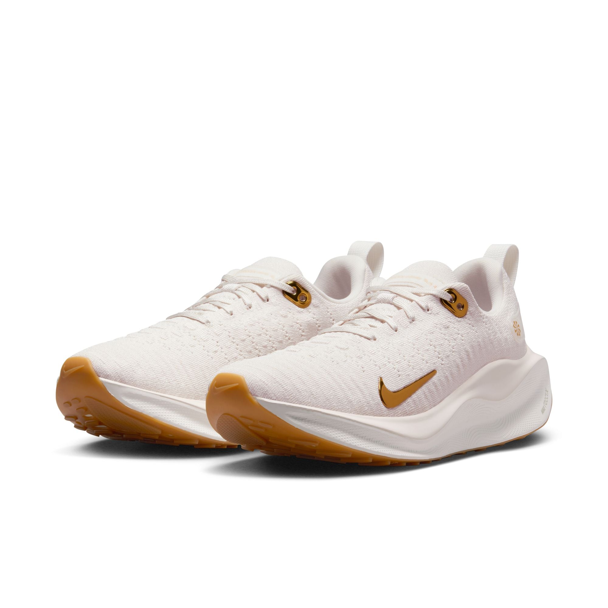 white and gold nike running shoes